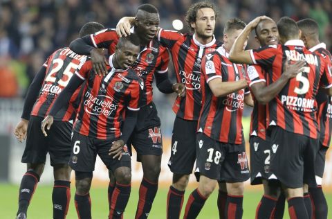 Nice's players celebrate after Nice's defender Jean-Michael Seri scored against Lyon during the League One soccer match between Nice and Lyon, in Nice stadium, southeastern France, Friday, Oct. 14, 2016. (AP Photo/Claude Paris)