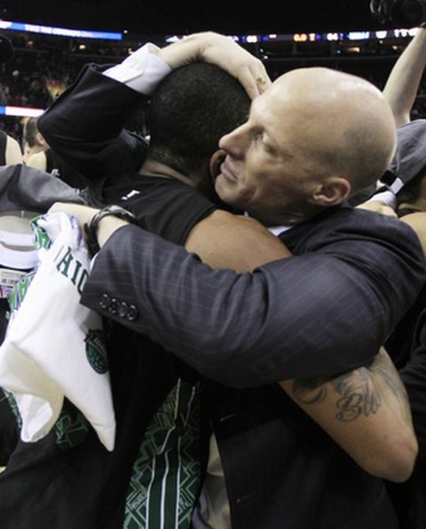 Ohio's head coach John Groce, right, hugs D.J. Cooper after they defeated Akron 64-63 in an NCAA college basketball championship game in the Mid-American Conference men's tournament on Saturday, March 10, 2012, in Cleveland.  (AP Photo/Tony Dejak)