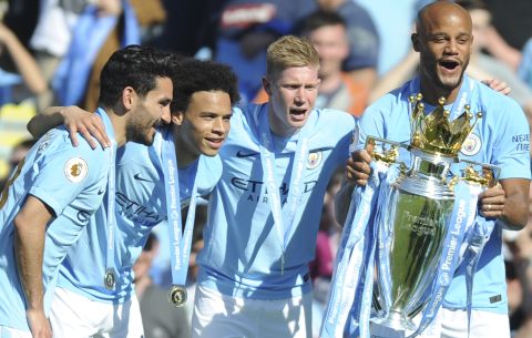 Manchester City players lift the English Premier League trophy after the soccer match between Manchester City and Huddersfield Town at Etihad stadium in Manchester, England, Sunday, May 6, 2018. (AP Photo/Rui Vieira)