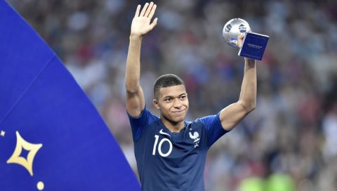 France's Kylian Mbappe poses with the best young player award after the final match between France and Croatia at the 2018 soccer World Cup in the Luzhniki Stadium in Moscow, Russia, Sunday, July 15, 2018. (AP Photo/Martin Meissner)