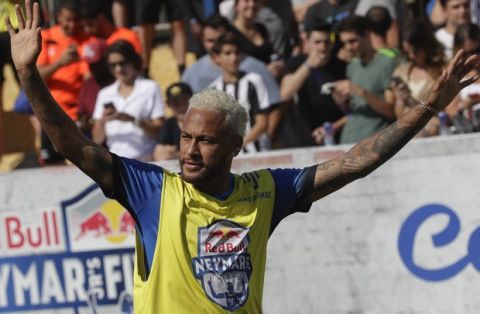 Brazilian soccer player Neymar acknowledges fans during the Neymar Jr's Five youth soccer tournament in Praia Grande, Brazil, Saturday, July 13, 2019. (AP Photo/Andre Penner)