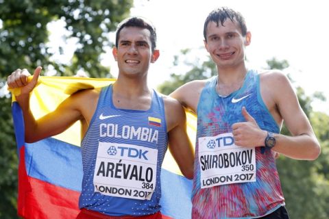Gold medal winner Colombia's Eider Arevalo, left, and silver medal winner Russia's Sergei Shirobokov pose after the men's 20-kilometer race walk at the World Athletics Championships in London Sunday, Aug. 13, 2017. (AP Photo/Kirsty Wigglesworth)