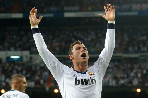 Real Madrid's Portuguese forward Cristiano Ronaldo celebrates after scoring during the UEFA Champions League Group D football match Real Madrid vs Mancherter City at Santiago Bernabeu stadium in Madrid on September 18, 2012. Real Madrid won 3-2.  AFP PHOTO / PIERRE-PHILIPPE MARCOU        (Photo credit should read PIERRE-PHILIPPE MARCOU/AFP/GettyImages)