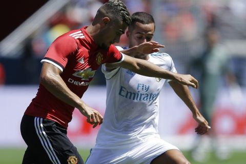 Manchester United's Andreas Pereira, right, and Real Madrid's Lucas Vazquez go for the ball during the first half of an international friendly soccer match Sunday, July 23, 2017, in Santa Clara, Calif. (AP Photo/Ben Margot)