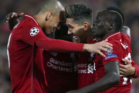 Liverpool's Roberto Firmino, center, celebrates after scoring his side's second goal during the Champions League quarterfinal, first leg, soccer match between Liverpool and FC Porto at Anfield Stadium, Liverpool, England, Tuesday April 9, 2019. (AP Photo/Dave Thompson)