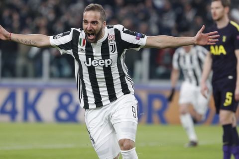 Juventus' Gonzalo Higuain celebrates after scoring his side's opening goal during the Champions League, round of 16, first-leg soccer match between Juventus and Tottenham Hotspurs, at the Allianz Stadium in Turin, Italy, Tuesday, Feb. 13, 2018. (AP Photo/Antonio Calanni)