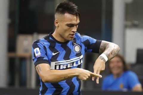 Inter Milan's Lautaro Martinez, rgesrtures as he celebrates after scoring g against Napoli, during the Serie A soccer match between Inter Milan and Napoli at the San Siro Stadium, in Milan, Italy, Tuesday, July 28, 2020. (AP Photo/Antonio Calanni)