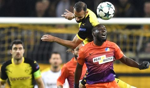 Dortmund's Omer Toprak, rear, jumps for the ball with APOEL Nicosia's Mickael Pote during the Champions League group H soccer match between Borussia Dortmund and APOEL Nicosia in Dortmund, Germany, Wednesday, Nov. 1, 2017. (AP Photo/Martin Meissner)