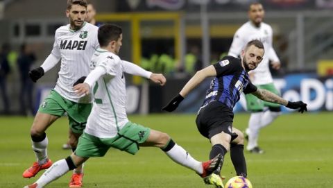 Sassuolo's Pol Lirola, left, and Inter Milan's Marcelo Brozovic vie for the ball during the Serie A soccer match between Inter Milan and Sassuolo, at the San Siro stadium in Milan, Italy, Saturday, Jan. 19, 2019. (AP Photo/Luca Bruno)