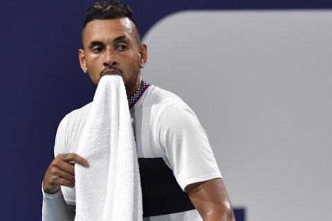 Nick Kyrgios, of Australia, takes a moment between points during a match against Dusan Lajovic, of Serbia, during the third round of the Miami Open tennis tournament, Sunday, March 24, 2019, in Miami Gardens, Fla. (AP Photo/Jim Rassol)