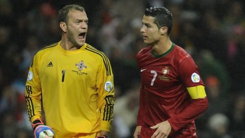 Northern Ireland's goalkeeper Roy Carroll, left, reacts as Portugal's Cristiano Ronaldo walks past during their World Cup Group F qualifying soccer match at the Dragao Stadium in Porto, Portugal, Tuesday Oct. 16, 2012. The match ended in a 1-1 draw.(AP Photo/Paulo Duarte)