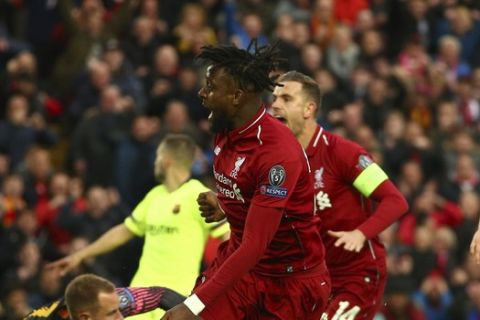 Liverpool's Divock Origi reacts next to Jordan Henderson during the Champions League semifinal, second leg, soccer match between Liverpool and FC Barcelona at the Anfield stadium in Liverpool, England, Tuesday, May 7, 2019. (AP Photo/Dave Thompson)