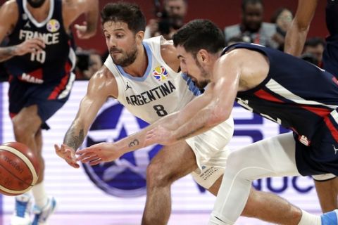 Nicolas Laprovittola of Argentina and Nando de Colo of France battle for a loose ball during their semifinal match in the FIBA Basketball World Cup at the Cadillac Arena in Beijing, Friday, Sept. 13, 2019. (AP Photo/Mark Schiefelbein)