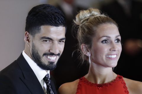 Uruguayan soccer star Luis Suarez and wife Sofia Balbi pose on the red carpet after attending the wedding of Lionel Messi and Antonella Roccuzzo, in Rosario, Argentina, Friday, June 30, 2017. About 250 guests, including teammates and former teammates of the Barcelona soccer star, attended the highly anticipated ceremony. (AP Photo/Victor R. Caivano)