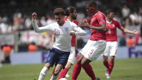 England's Dele Alli, left, and Switzerland's Manuel Akanji challenge for the ball during the UEFA Nations League third place soccer match between Switzerland and England at the D. Afonso Henriques stadium in Guimaraes, Portugal, Sunday, June 9, 2019. (AP Photo/Luis Vieira)