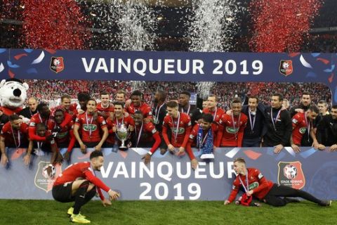 Team of Rennes celebrate with trophy after winning the French Cup soccer final between Rennes and Paris Saint Germain at the Stade de France stadium in Saint-Denis, outside Paris, France, Saturday, April 27, 2019. (AP Photo/Thibault Camus)