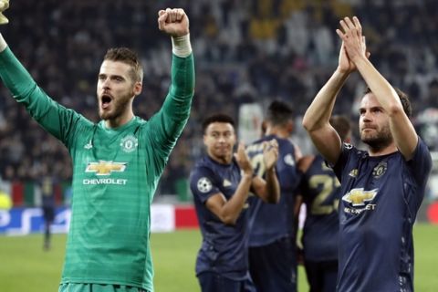 Manchester United's goalkeeper David de Gea, left, and Juan Mata celebrate at the end of the Champions League group H soccer match between Juventus and Manchester United at the Allianz stadium in Turin, Italy, Wednesday, Nov. 7, 2018. Manchester won 2-1. (AP Photo/Antonio Calanni)