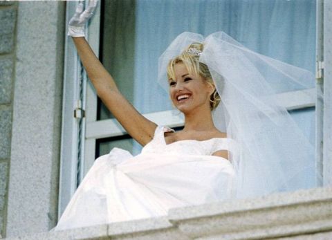 Slovak top-model Adriana Sklenarikova waves to the crowd from the Porto-Vecchio, Corsica,  City Hall window after her civil wedding with French soccer player Christian Karembeu Tuesday Dec. 22, 1998. Karembeu was on the World Cup winning French team and now plays with Spanish team Real Madrid. (AP Photo/Mediasud)