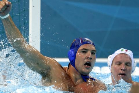Serbia's Slobodan Nikic reacts after scoring a goal against Italy during a men's semifinal water polo match at the 2012 Summer Olympics, Friday, Aug. 10, 2012, in London. (AP Photo/Julio Cortez)