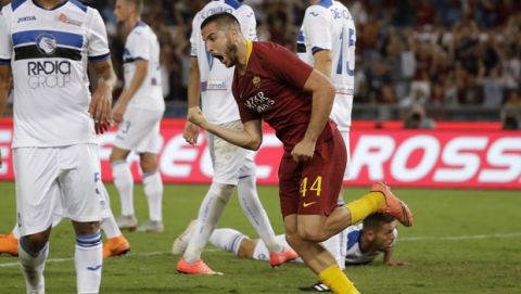 Roma's Kostas Manolas, center, celebrates after scoring his side's third goal during a Serie A soccer match between Roma and Atalanta, in Rome's Olympic stadium, Monday, Aug. 27, 2018. (AP Photo/Andrew Medichini)