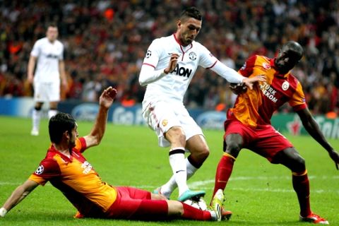 Manchester United's Federico Macheda, center, fights for the ball with Albert Riera, left, and Dany Nounkeu of Galatasaray during their Champions League group H soccer match at TT Arena Stadium in Istanbul, Turkey, Tuesday, Nov. 20, 2012. (AP Photo)