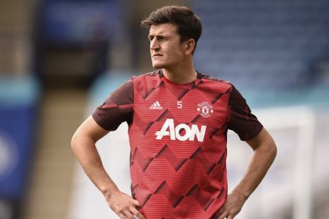 Manchester United's Harry Maguire looks on during warm up before the English Premier League soccer match between Leicester City and Manchester United at the King Power Stadium, in Leicester, England, Sunday, July 26, 2020. (Oli Scarff/Pool via AP)