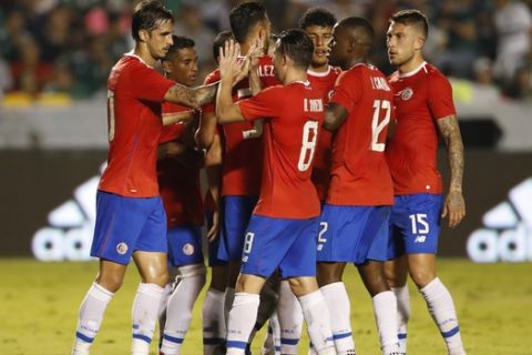 Costa Rica's Bryan Ruiz, left, is congratulated by teammates after scoring a goal on a penalty kick during a friendly soccer match between Mexico and Costa Rica in Monterrey, Mexico, Thursday, Oct. 11, 2018. (AP Photo/Eduardo Verdugo)