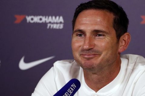 Chelsea's manager Frank Lampard smiles as he listens to a question during a media conference at the teams training ground in Cobham, England, Friday, Aug. 9, 2019. Chelsea play Manchester United in Manchester on Sunday in their opening English Premier League 2019/2020 fixture. (AP Photo/Alastair Grant)