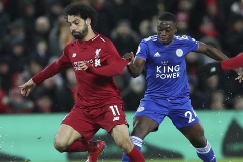 Liverpool forward Mohamed Salah, left, is tackled by Leicester City midfielder Nampalys Mendy during the English Premier League soccer match between Liverpool and Leicester City, at Anfield Stadium, Liverpool, England, Wednesday, Jan.29, 2019. (AP Photo/Jon Super)