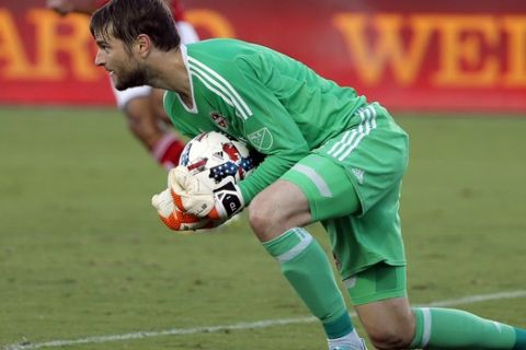 Houston Dynamo goalkeeper Tyler Deric controls a shot by FC Dallas in the first half of an MLS soccer game, Wednesday, Aug. 23, 2017, in Frisco, Texas. (AP Photo/Tony Gutierrez)