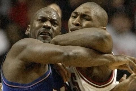 Washington Wizards' Michael Jordan, left, and Chicago Bulls' Ron Artest battle for position during the fourth quarter Saturday, Jan. 19, 2002, in Chicago. Jordan scored 16 points in his return to Chicago in the Wizards 77-69 win. (AP Photo/Paul Sancya)