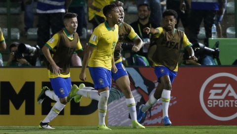 Brazil's Kaio Jorge, center, celebrates with teammates after scoring his side's first goal against Mexico during the FIFA U-17 World Cup Brazil 2019 final soccer match at Arena Bezerrao in Brasilia, Brazil, Sunday, Nov. 17, 2019. (AP Photo/Eraldo Peres)