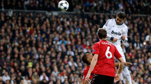 Real Madrid's Portuguese forward Cristiano Ronaldo (top) heads the ball to score during the UEFA Champions League round of 16 first leg football match Real Madrid CF vs Manchester United FC at the Santiago Bernabeu stadium in Madrid on February 13, 2013.  AFP PHOTO / CESAR MANSO        (Photo credit should read CESAR MANSO/AFP/Getty Images)