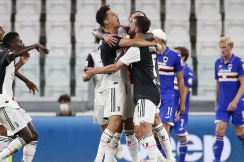 Juventus' Cristiano Ronaldo, centre, celebrates with his teammates after scoring his team's first goal during the Serie A soccer match between Juventus and Sampdoria at the Allianz stadium in Turin, Italy, Sunday, July 26, 2020. (AP Photo/Antonio Calanni)