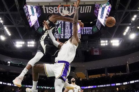 Milwaukee Bucks' Giannis Antetokounmpo blocks the shot of Los Angeles Lakers' LeBron James during the second half of an NBA basketball game Friday, Dec. 2, 2022, in Milwaukee. (AP Photo/Morry Gash)