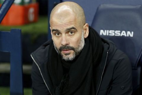 Manchester City manager Pep Guardiola awaits the start of the English Premier League soccer match Manchester City versus West Bromwich Albion at The Etihad Stadium, Manchester, England, Wednesday Jan. 31, 2018. (Martin Rickett/PA via AP)