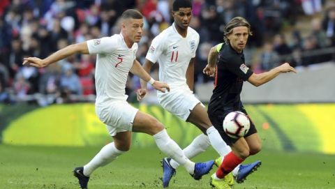 Croatia's Luka Modric, right, vies for the ball with England's Ross Barkley, left, and Marcus Rashford during the UEFA Nations League soccer match between England and Croatia at Wembley stadium in London, Sunday Nov. 18, 2018. (AP Photo/Rui Vieira)