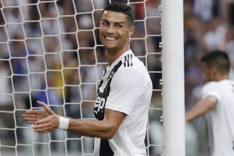 Juventus' Cristiano Ronaldo celebrates after his teammate Mario Mandzukic scored during a Serie A soccer match between Juventus and Lazio, at the Allianz stadium in Turin, Italy,Saturday, Aug. 25, 2018. (AP Photo/Luca Bruno)