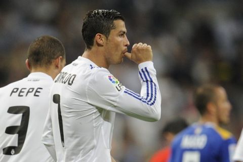 Real Madrid's Portuguese forward Cristiano Ronaldo celebrates after scoring during the Spanish League football match Real Madrid against Getafe at the Santiago Bernabeu stadium in Madrid, on May 10, 2011. AFP PHOTO/JAVIER SORIANO (Photo credit should read JAVIER SORIANO/AFP/Getty Images)
