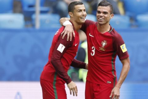 Portugal's Cristiano Ronaldo, left, celebrates with Pepe after scoring his side's first goal during the Confederations Cup, Group A soccer match between New Zealand and Portugal, at the St. Petersburg Stadium, Russia, Saturday, June 24, 2017. (AP Photo/Pavel Golovkin)