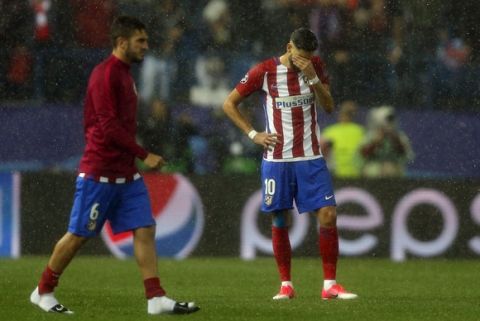 Atletico's Yannick Carrasco, right, looks dejected at the end of a Champions League semifinal, 2nd leg soccer match between Atletico de Madrid and Real Madrid, in Madrid, Spain, Wednesday, May 10, 2017 . (AP Photo/Daniel Ochoa de Olza)