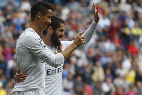 Real Madrid's Cristiano Ronaldo, left, celebrates with teammate Francisco Roman Isco after scoring their team's second goal against Las Palmas during the Spanish La Liga soccer match between Real Madrid and Las Palmas at the Santiago Bernabeu stadium in Madrid, Saturday, Oct. 31, 2015. Isco and Ronaldo scored once each in Real Madrid's 3-1 victory. (AP Photo/Francisco Seco)