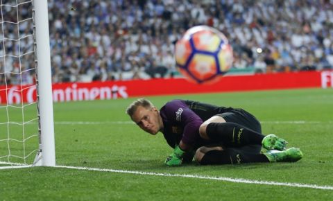 Barcelona's goalkeeper Marc-Andre Ter Stegen saves on an attempt to score by Real Madrid's Karim Benzema during a Spanish La Liga soccer match between Real Madrid and Barcelona, dubbed 'el clasico', at the Santiago Bernabeu stadium in Madrid, Spain, Sunday, April 23, 2017. (AP Photo/Francisco Seco)