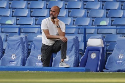Manchester City's head coach Pep Guardiola rests on the bench ahead of the English Premier League soccer match between Chelsea and Manchester City at Stamford Bridge, in London, England, Thursday, June 25, 2020. (AP Photo/Paul Childs,Pool)
