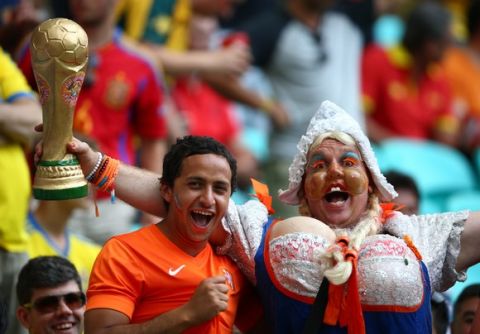 SALVADOR, BRAZIL - JUNE 13: Fans of the Netherlands cheer in the crowd while holding a replica of the World Cup trophy during the 2014 FIFA World Cup Brazil Group B match between Spain and Netherlands at Arena Fonte Nova on June 13, 2014 in Salvador, Brazil.  (Photo by Paul Gilham/Getty Images)