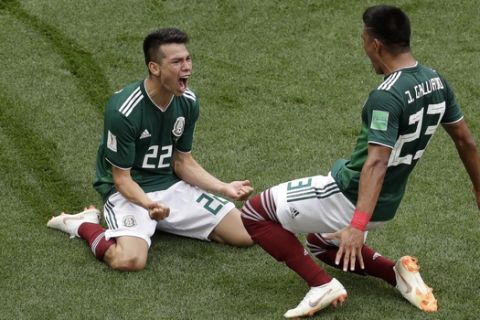 Mexico's Hirving Lozano, left, celebrates with his teammate Jesus Gallardo after scoring the opening goal during the group F match between Germany and Mexico at the 2018 soccer World Cup in the Luzhniki Stadium in Moscow, Russia, Sunday, June 17, 2018. (AP Photo/Michael Probst)