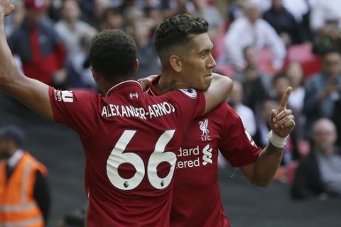 Liverpool's Roberto Firmino, center reacts after he scored his side second goal during the English Premier League soccer match between Tottenham Hotspur and Liverpool at Wembley Stadium in London, Saturday Sept. 15, 2018. (AP Photo/Tim Ireland)