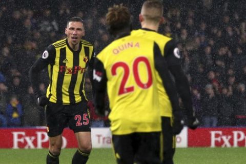 Watford's Jose Holebas, left,  celebrates scoring his side's second goal of the game during the English Premier League soccer match between Watford F.C and Cardiff City at Vicarage Road stadium, London, England. Saturday Dec. 15, 2018. (Yoi Mok/PA via AP)