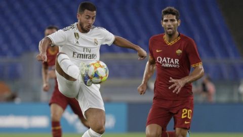 Real forward Eden Hazard, left, and Roma defender Federico Fazio vie for the ball during a friendly soccer match between Roma and Real Madrid, at the Olympic stadium in Rome, Sunday, Aug. 11, 2019. (AP Photo/Gregorio Borgia)
