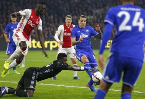 Ajax's goalkeeper Andre Onana saves before Kobenhavn's Federico Santander, second right, can score during Europa League round of 16, second leg, soccer match between Ajax and Kobenhavn at the Amsterdam ArenA stadium in Amsterdam, Netherlands, Thursday, March 16, 2017. (AP Photo/Peter Dejong)